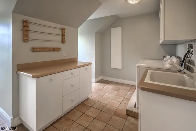 a kitchen with a sink cabinets and a stove top oven