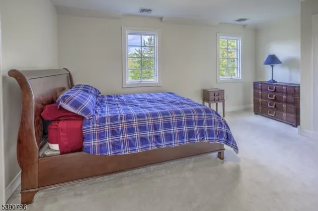 a bedroom with bed and a window