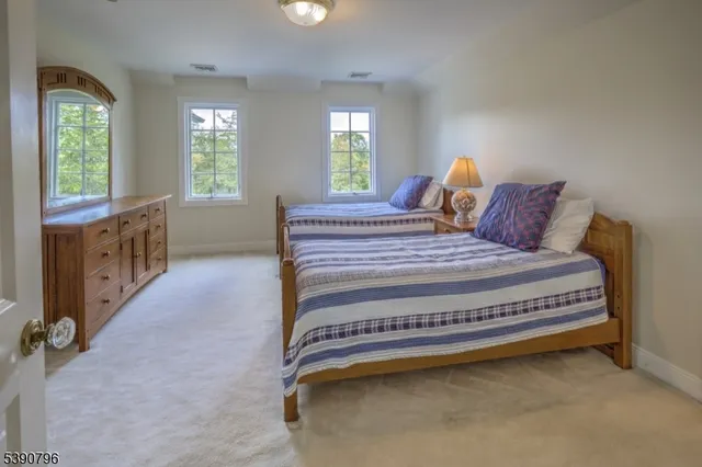 a bed sitting in a bedroom next to a window