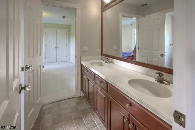 a bathroom with a double vanity sink and mirror