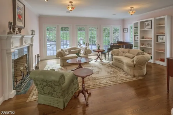 a living room with furniture a fireplace and a large window