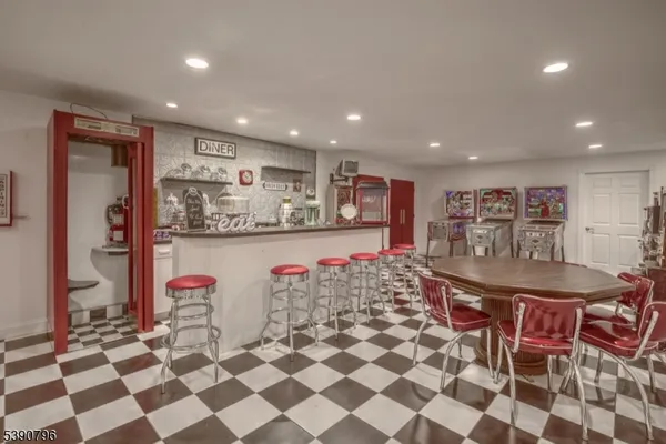a kitchen with stainless steel appliances kitchen island granite countertop a sink and a refrigerator