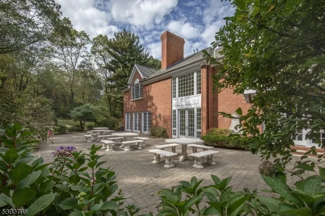 a view of a house with a small yard and tree s