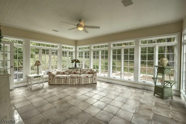 a living room with furniture and large windows