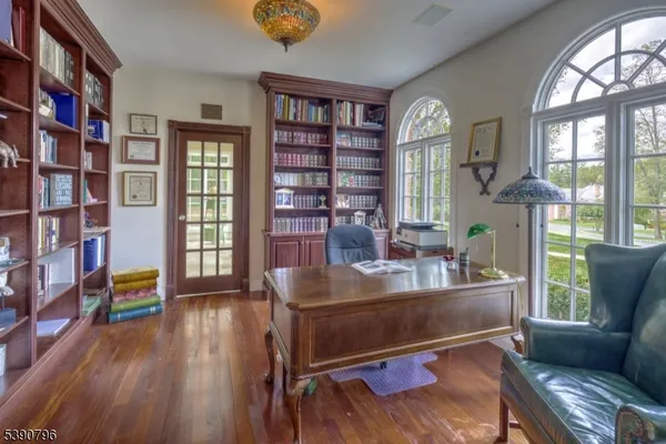 a living room with furniture and a book shelf