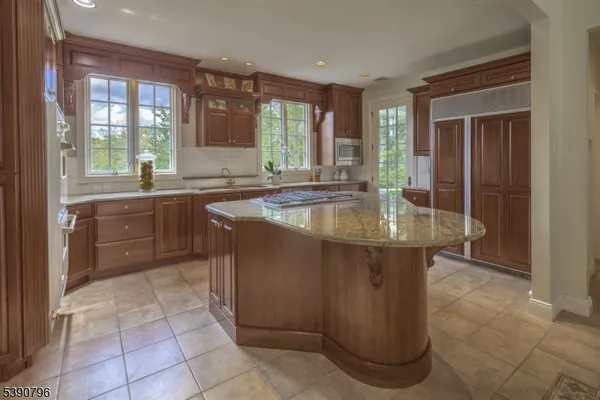 a dining hall with granite countertop a sink and dishwasher