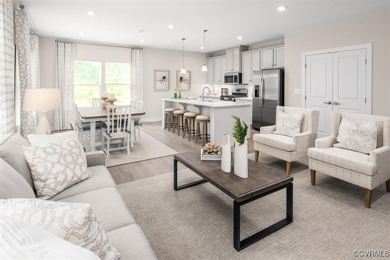 4100 Maze Runner Drive, Unit 303 Midlothian, VA 23112 - Photo 1 of 8 Living room with light wood finished floors, baseb