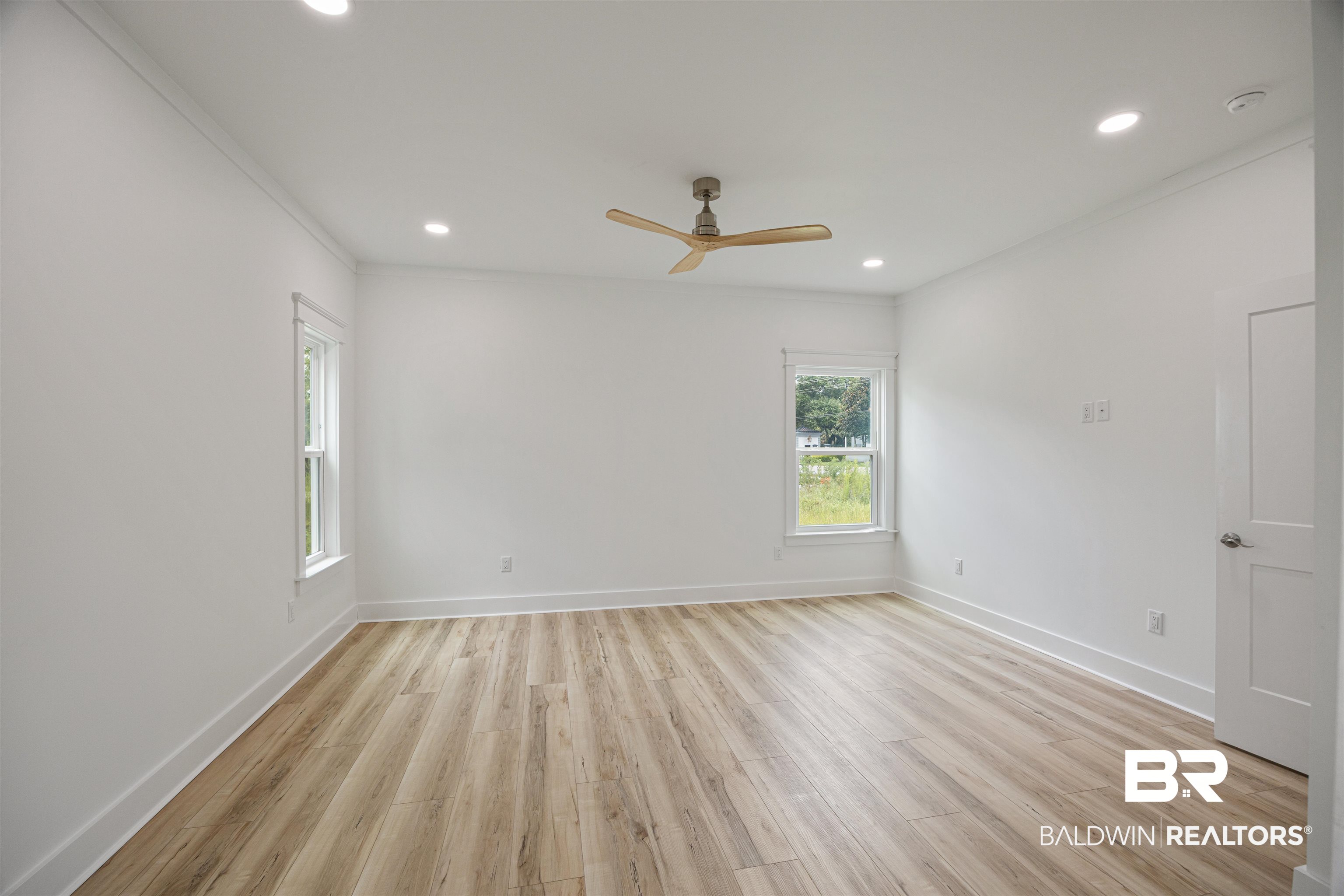 27591 Canal Road Orange Beach, AL 36561 - Photo 20 of 51 Empty room featuring light wood-style flooring, a ceiling fan, recessed lighting, and ornamental molding