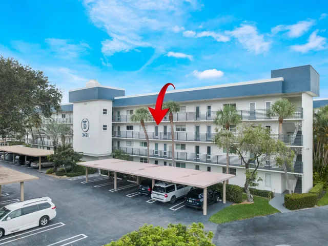 a view of a patio with swimming pool and table and chairs
