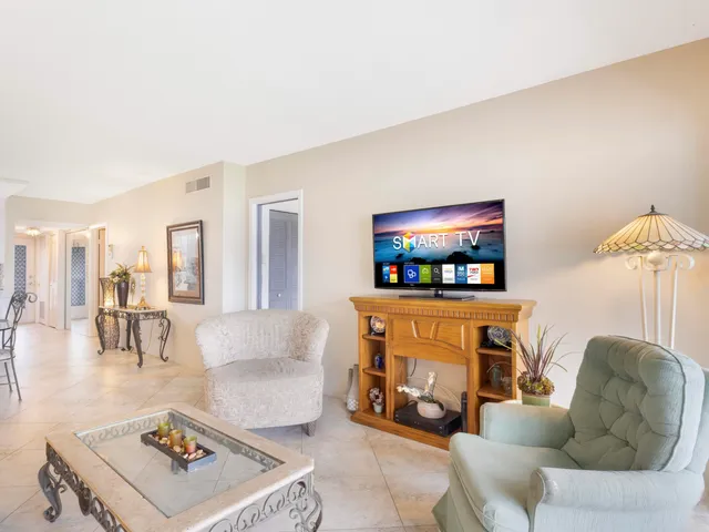 a bathroom with a sink a toilet a mirror and shower