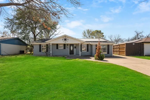 a front view of a house with a garden and yard