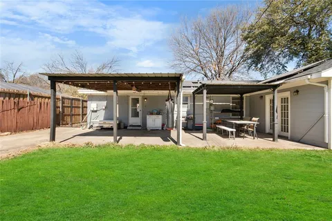 a view of a backyard with sitting area and slide