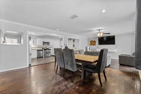a view of a dining room with furniture and wooden floor