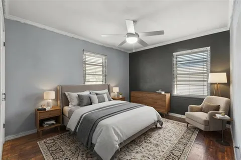 a bedroom with a bed couch and a window