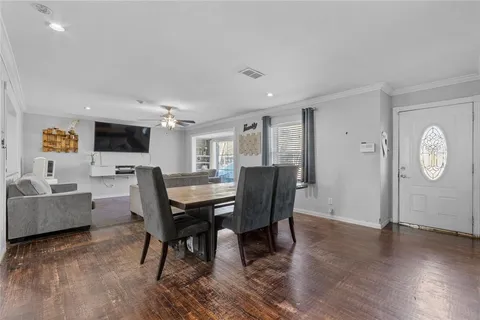 a view of a dining room with furniture and wooden floor
