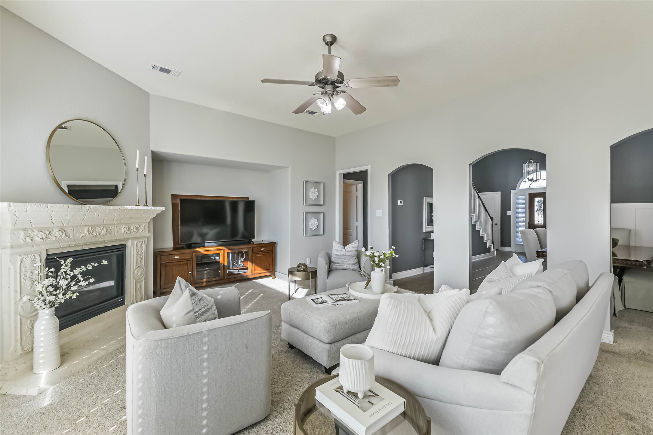 19022 Greenleaf Ridge Court Cypress, TX 77429 - Photo 14 of 47 a living room with furniture a fireplace and a flat screen tv