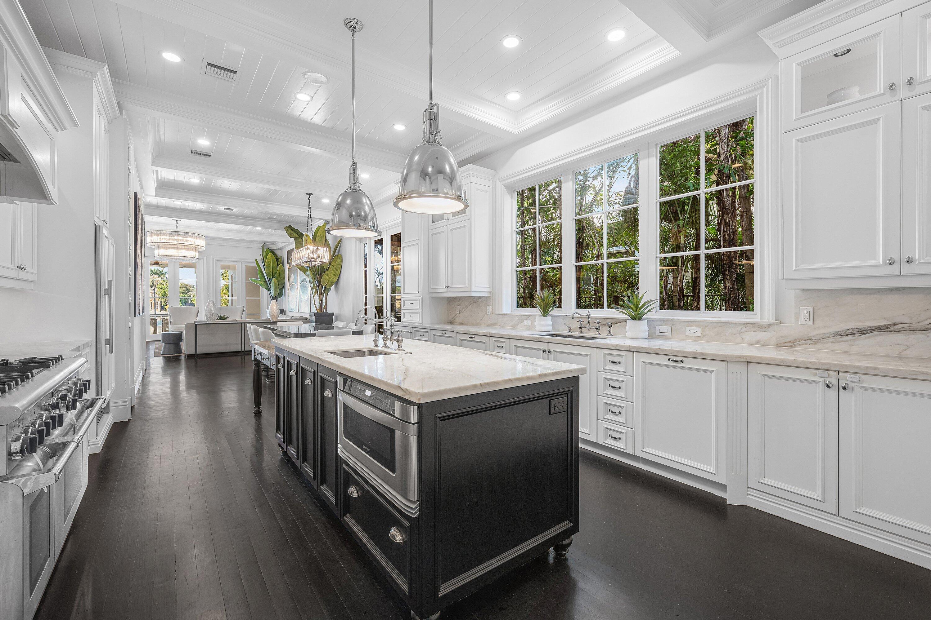 485 Northeast Spanish Trail Boca Raton, FL 33432 - Photo 21 of 76 a kitchen with stainless steel appliances granite countertop a stove and a large window