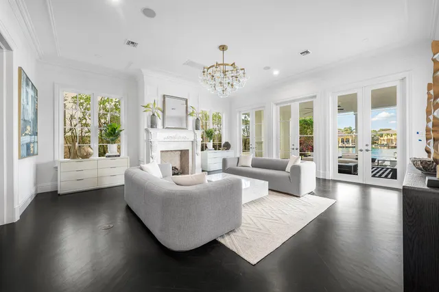 a spacious bedroom with a bed mirror and couch