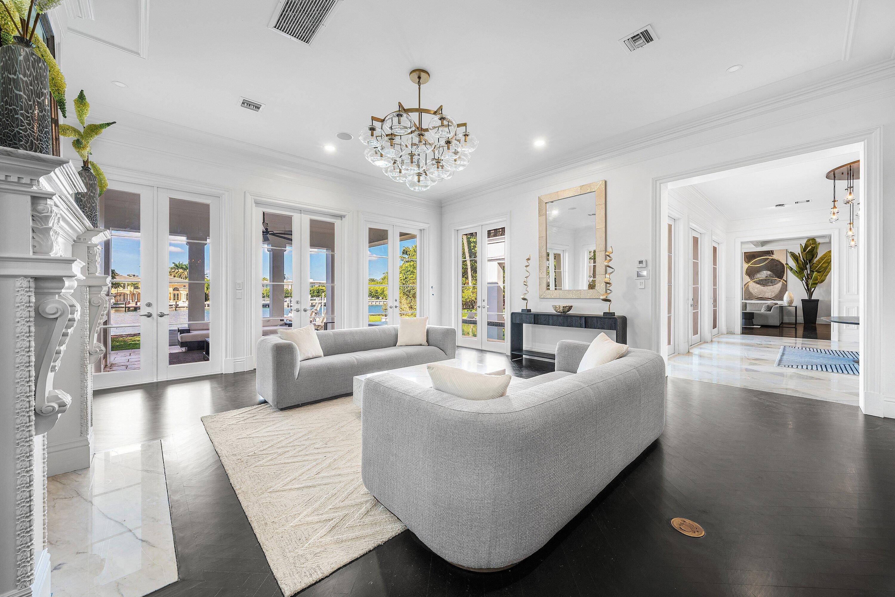 485 Northeast Spanish Trail Boca Raton, FL 33432 - Photo 36 of 76 a living room with furniture and a chandelier