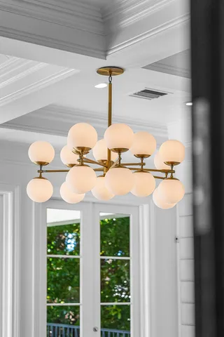 an aerial view of a city with lots of residential buildings ocean and mountain view in back