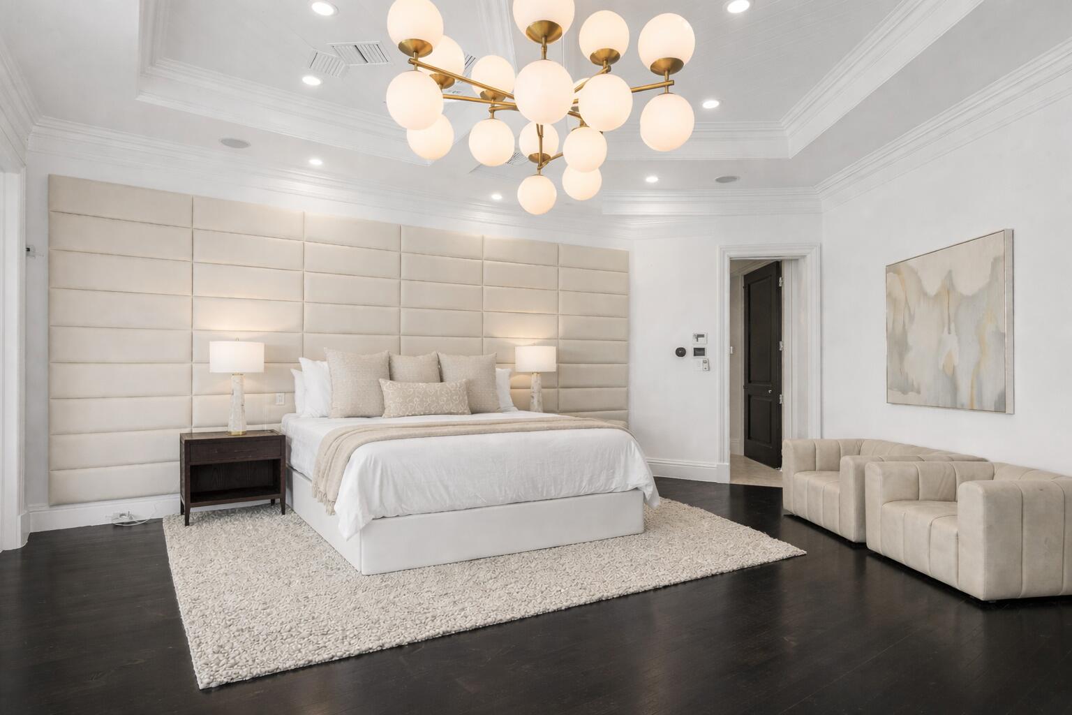 485 Northeast Spanish Trail Boca Raton, FL 33432 - Photo 52 of 76 a spacious bedroom with a bed mirror and couch