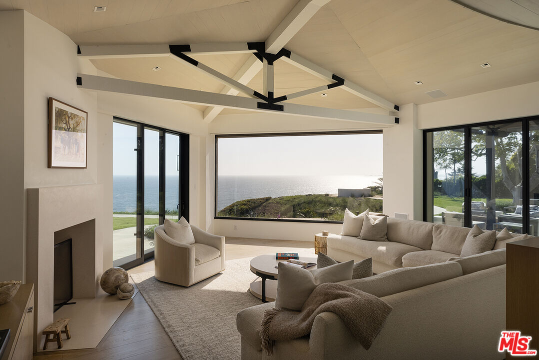 4145 Creciente Drive Santa Barbara, CA 93110 - Photo 12 of 57 a living room with furniture and a floor to ceiling window
