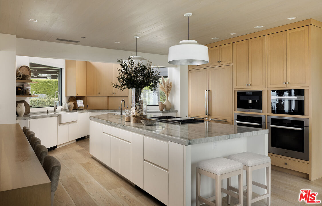 4145 Creciente Drive Santa Barbara, CA 93110 - Photo 15 of 57 a kitchen with stainless steel appliances a sink a stove and a center island