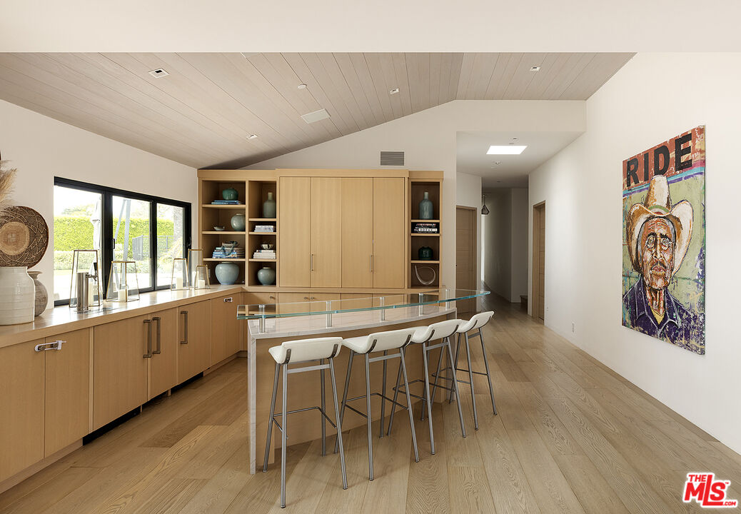 4145 Creciente Drive Santa Barbara, CA 93110 - Photo 17 of 57 a kitchen with stainless steel appliances kitchen island granite countertop a table and chairs in it