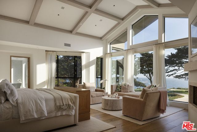 a bathroom with a granite countertop sink a large mirror and a bathtub
