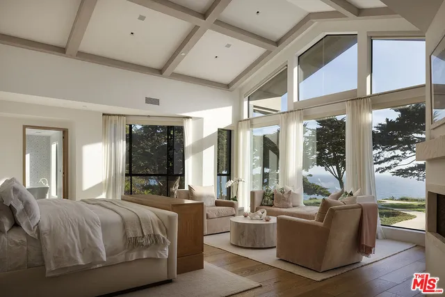 a bathroom with a granite countertop sink a large mirror and a bathtub