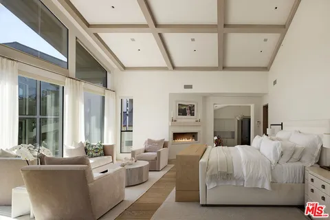 a living room with furniture and a book shelf