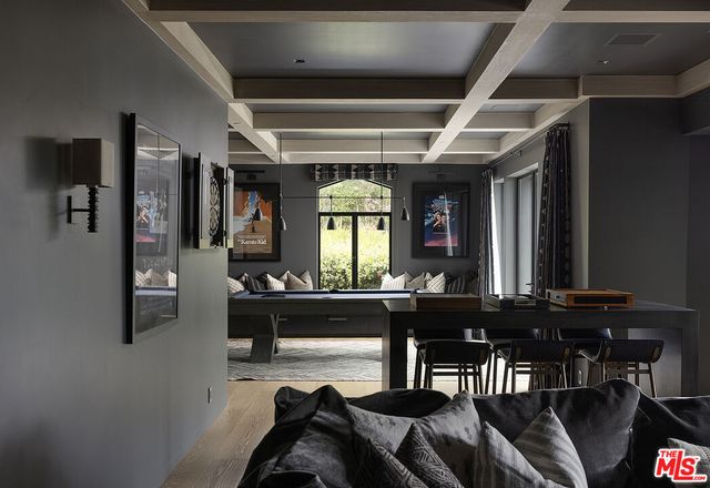 a view of a hallway with windows and chandelier