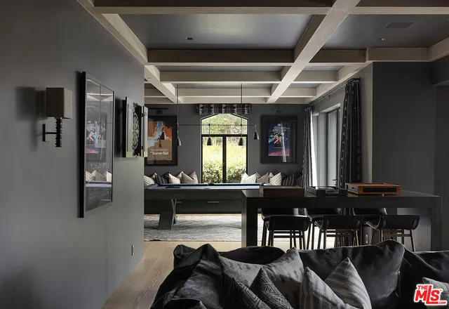 a view of a hallway with windows and chandelier