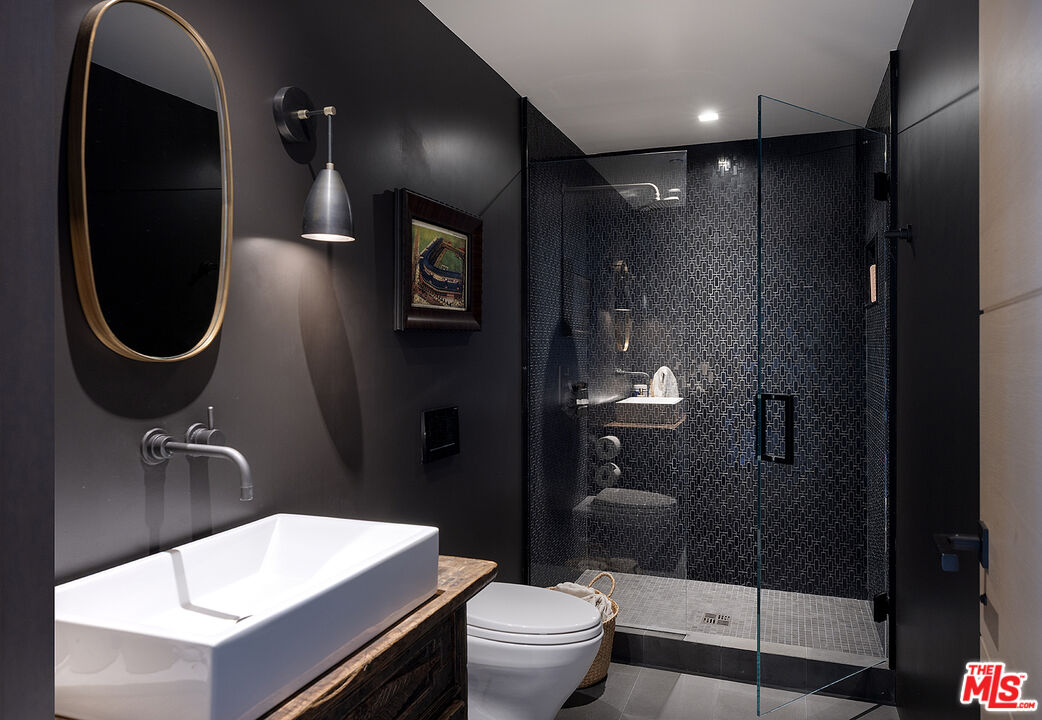 4145 Creciente Drive Santa Barbara, CA 93110 - Photo 35 of 57 a bathroom with a toilet a sink and mirror