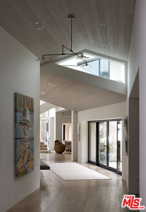 4145 Creciente Drive Santa Barbara, CA 93110 - Photo 36 of 57 a view of a hallway with windows and chandelier