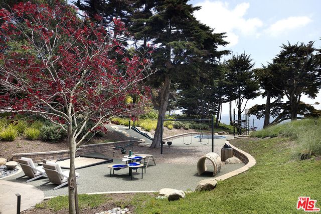 a front view of a building with a garden