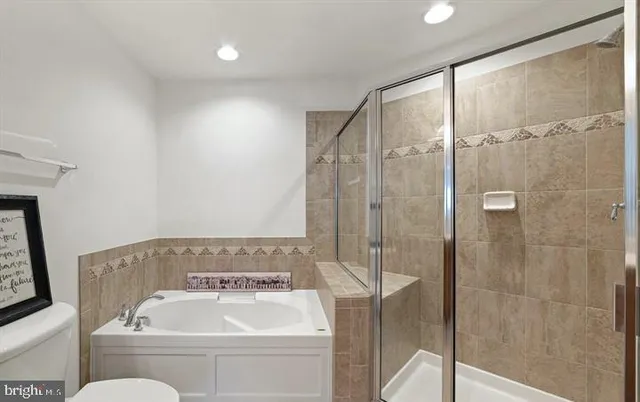 a bedroom with two beds and a large window