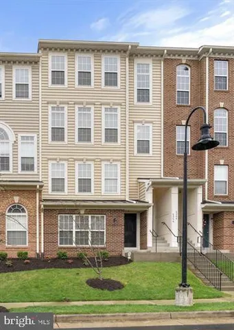 a living room with furniture flat screen tv and wooden floor
