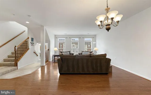 a kitchen with stainless steel appliances a stove a sink a microwave a refrigerator and cabinets