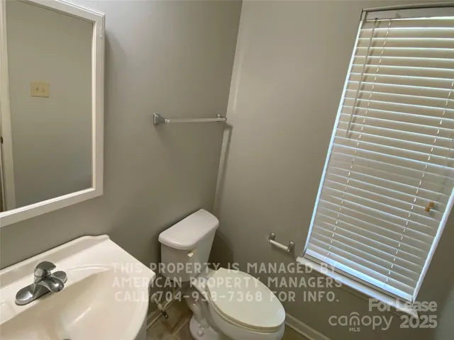 a white toilet sitting next to a bathroom sink