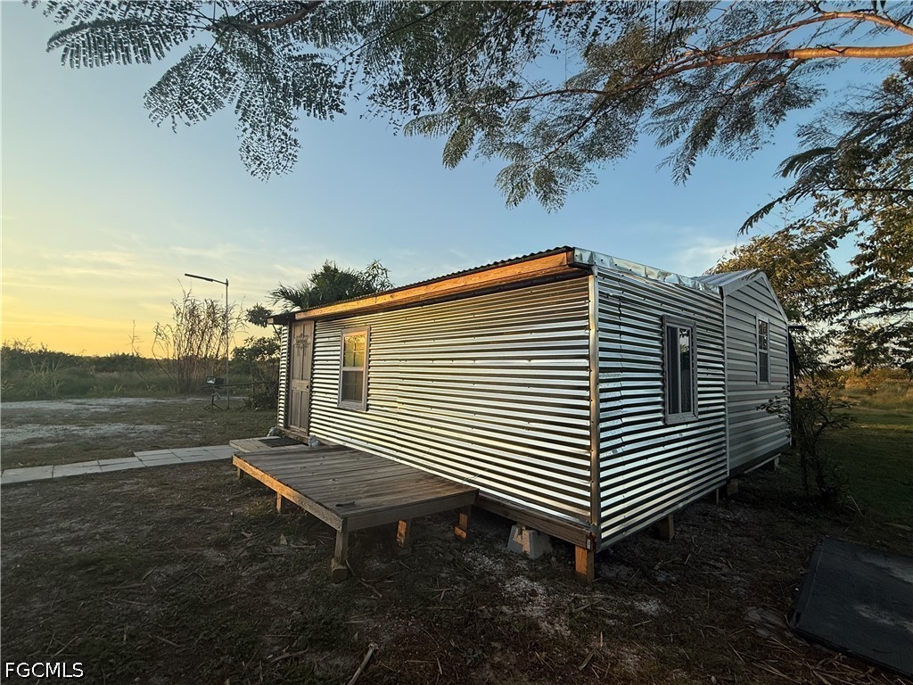 6724 5th Road LaBelle, FL 33935 - Photo 17 of 28 a backyard of a house with table and chairs
