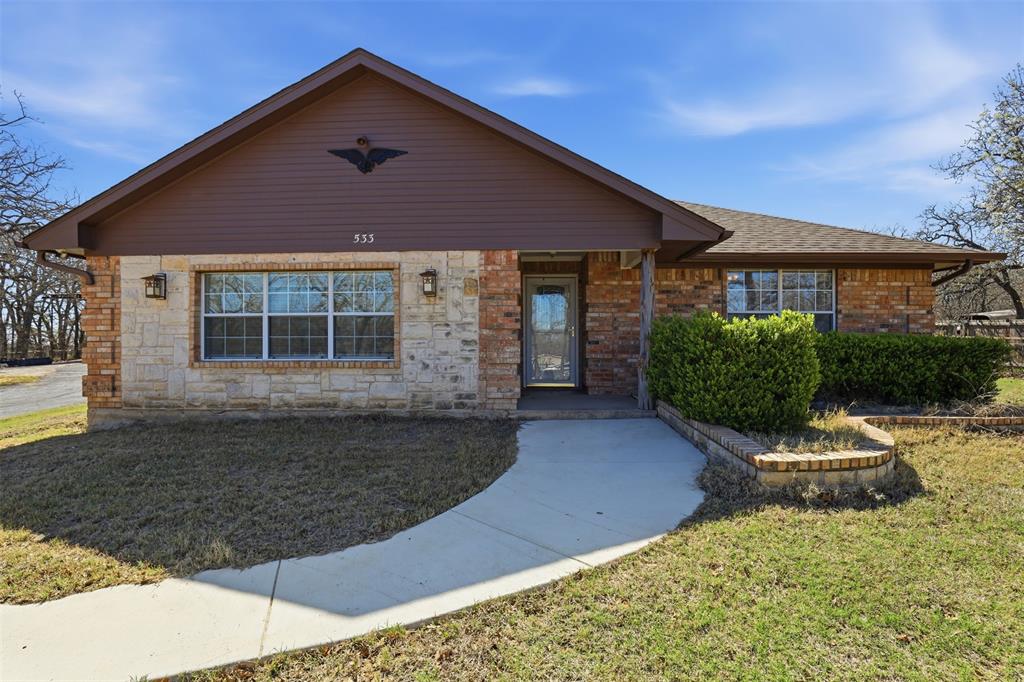 533 Eagles Way Springtown, TX 76082 - Photo 1 of 32 a front view of a house with garden