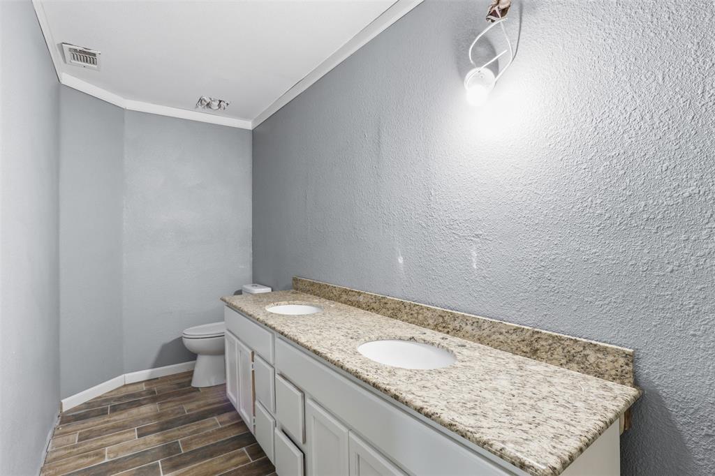 533 Eagles Way Springtown, TX 76082 - Photo 11 of 32 a bathroom with a granite countertop sink and toilet