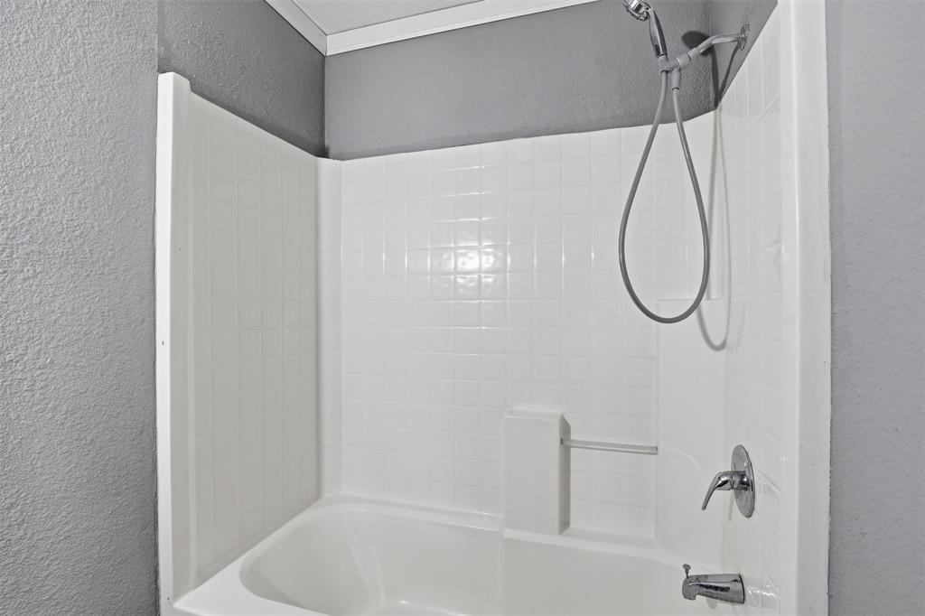 533 Eagles Way Springtown, TX 76082 - Photo 12 of 32 a bathroom with a bath tub with a shower