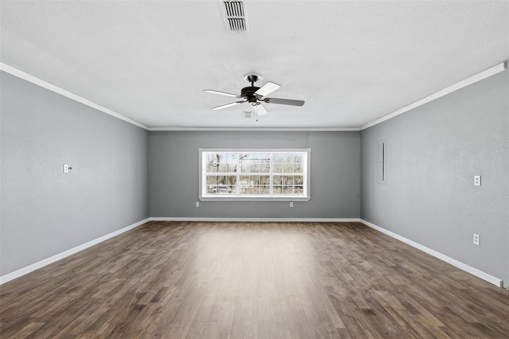 533 Eagles Way Springtown, TX 76082 - Photo 14 of 32 wooden floor in an empty room with a window