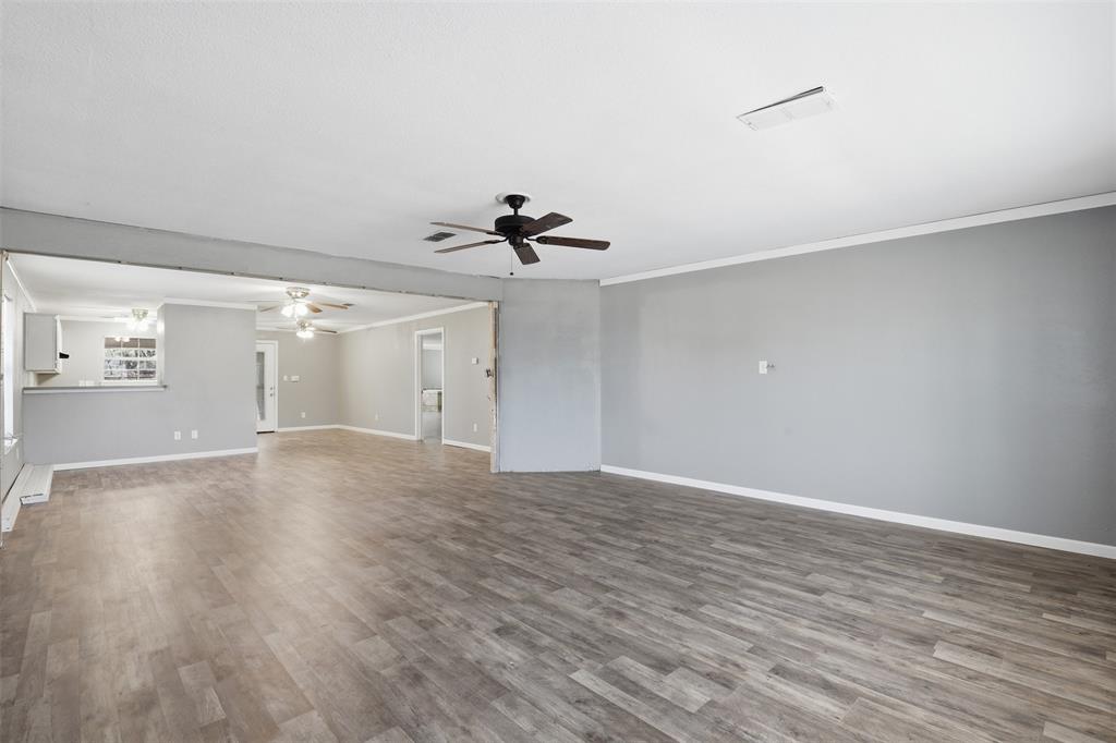 533 Eagles Way Springtown, TX 76082 - Photo 15 of 32 a view of empty room with wooden floor and ceiling fan