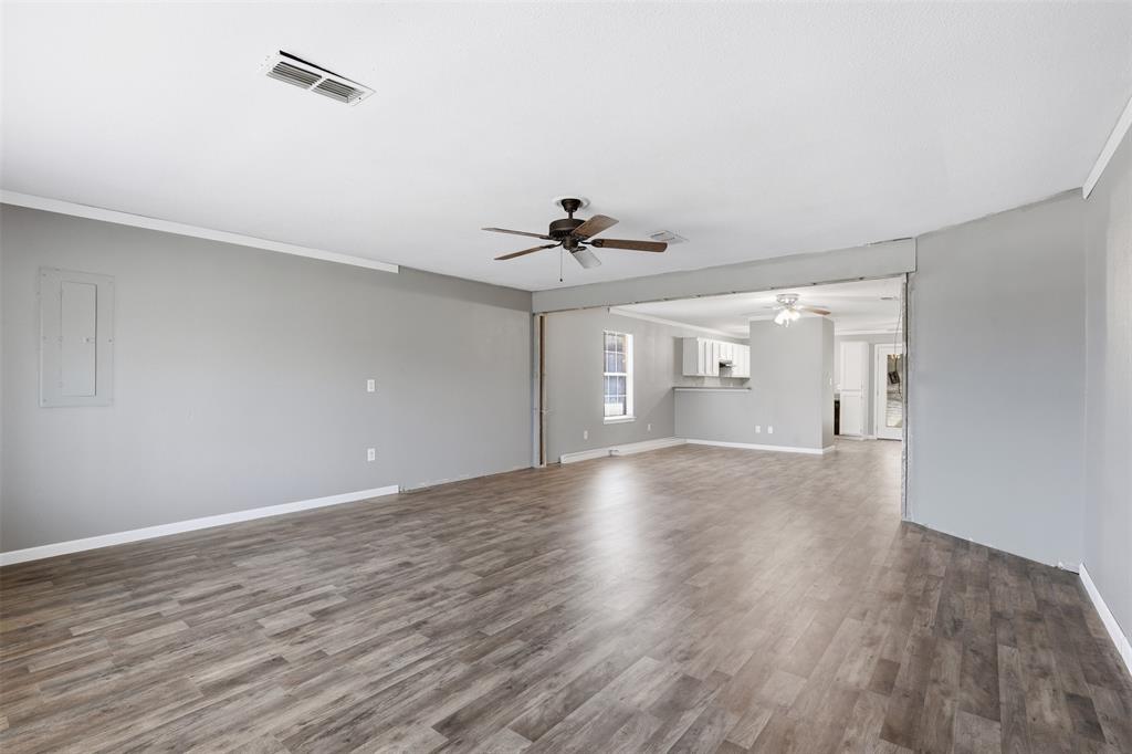 533 Eagles Way Springtown, TX 76082 - Photo 16 of 32 a view of an empty room with a window and wooden floor