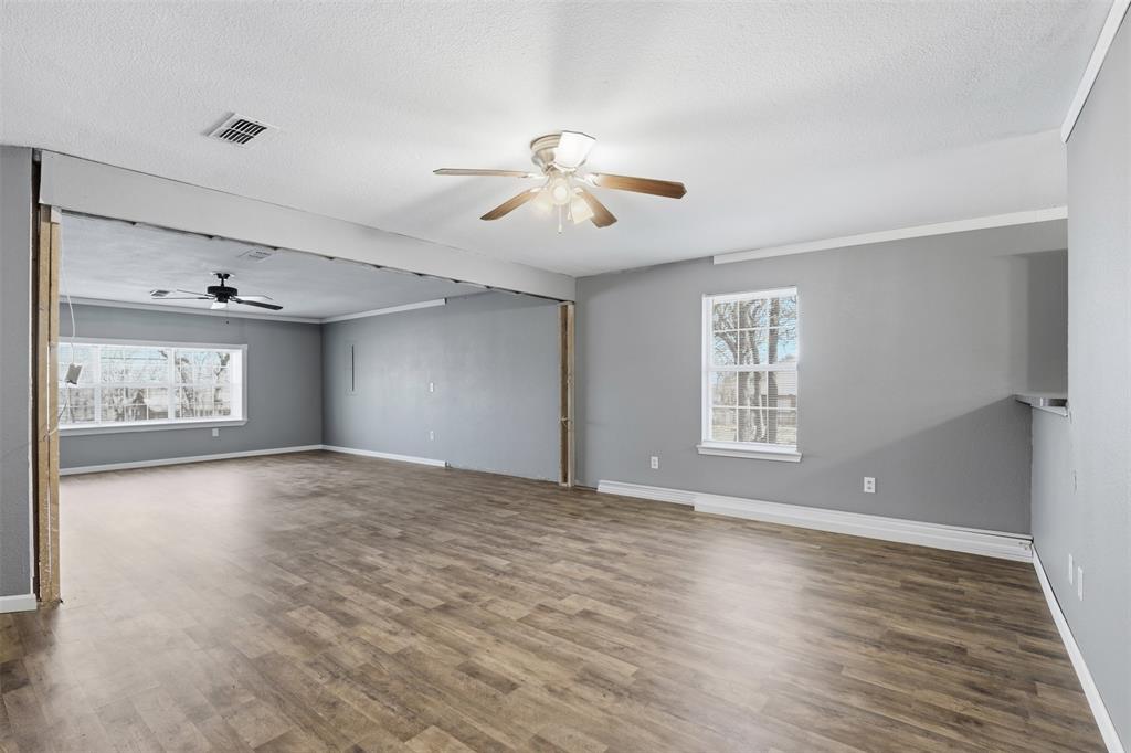 533 Eagles Way Springtown, TX 76082 - Photo 18 of 32 a view of empty room with wooden floor and fan