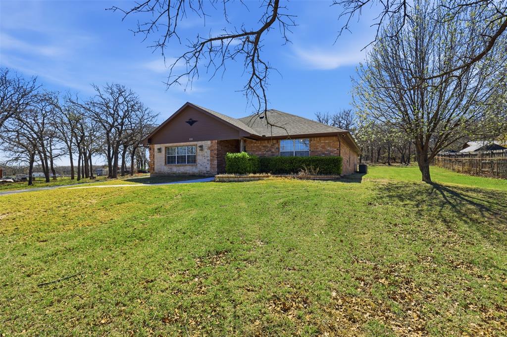 533 Eagles Way Springtown, TX 76082 - Photo 2 of 32 a front view of a house with a yard