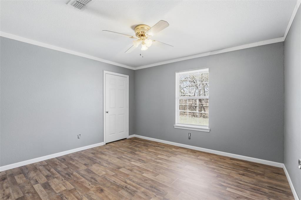 533 Eagles Way Springtown, TX 76082 - Photo 7 of 32 wooden floor in an empty room with a window